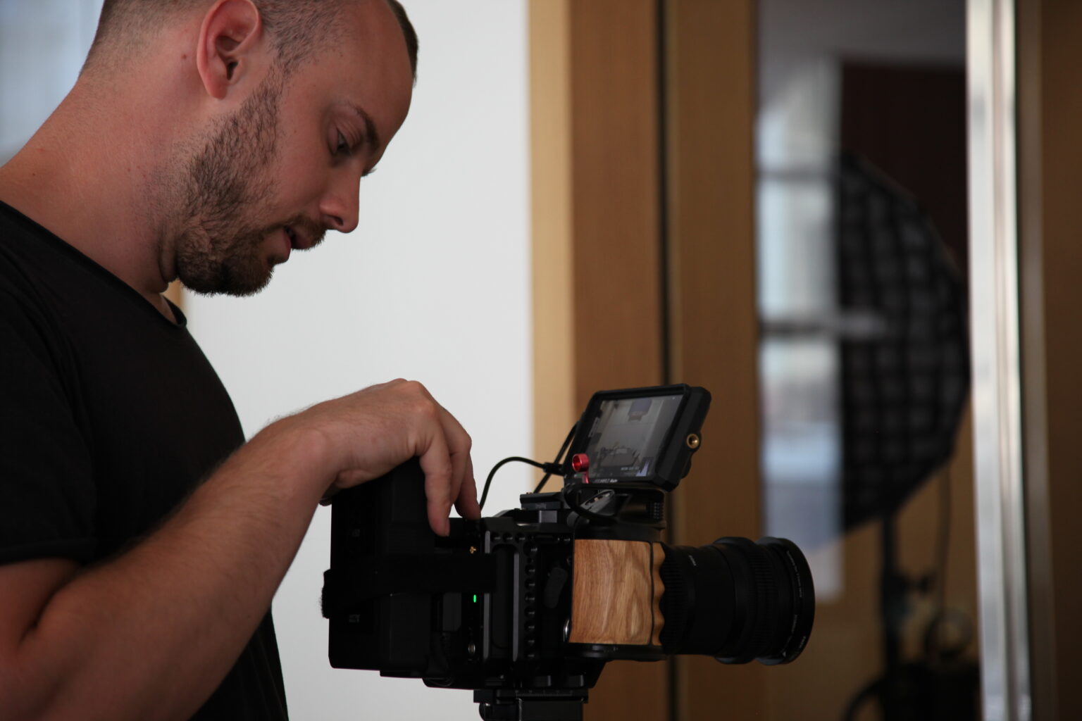Marvin Meyer setting up a cinema camera on set.