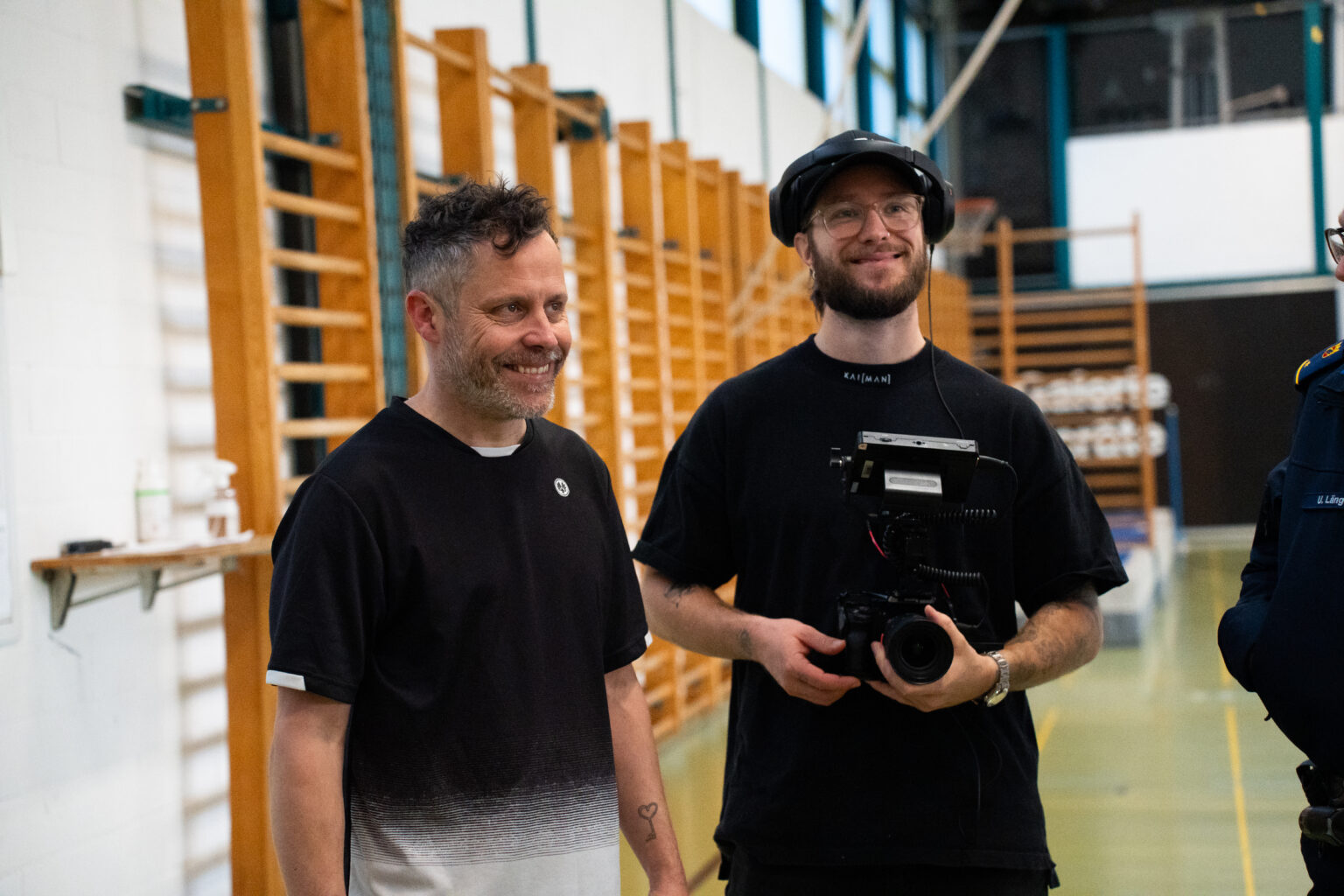 Two crew members smiling on a MAWA Film set.
